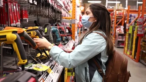 Woman Holds A Drill Inside A HardWare Store. Close Up. Stock Footage