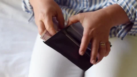 Woman holds large stack of 200 Turkish lira bills in front of her, spreads it Stock Footage 284483260