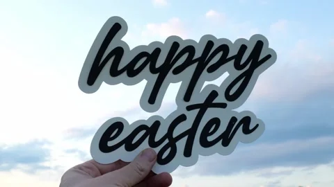Woman Holds Up A Message of Happy Easter Wording in front of Cloudy Sky 4K Video stock 317085996