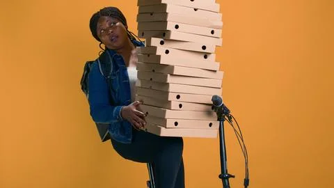 Woman holds stack of boxes for delivery Foto stock