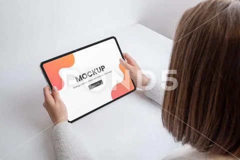 Woman holds tablet on workdesk mockup PSD Template