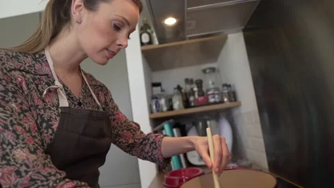 Woman in home kitchen preparing stew Stock Footage 151002145
