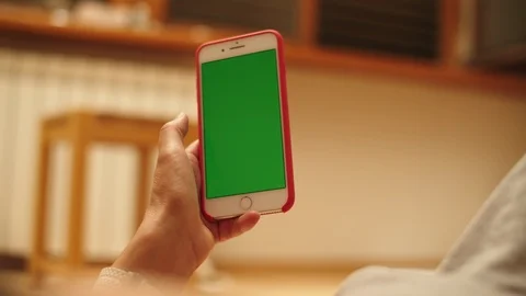 Woman at Home Lying on a Couch using Smartphone with Green Mock-up Screen, Doing Stock-Footage 111382800