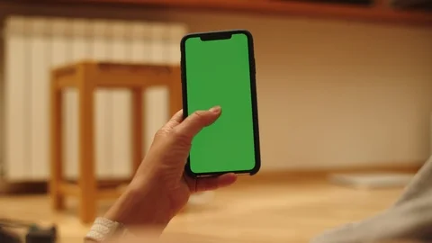 Woman at Home Lying on a Couch using Smartphone with Green Mock-up Screen, Doing Stock-Footage 111405413