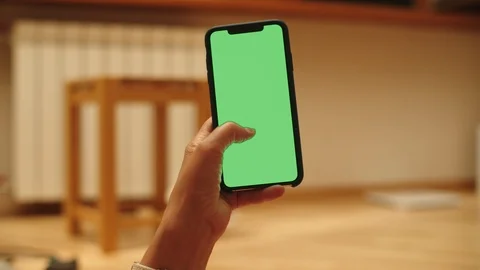 Woman at Home Lying on a Couch using Smartphone with Green Mock-up Screen, Doing Stock-Footage 111405804