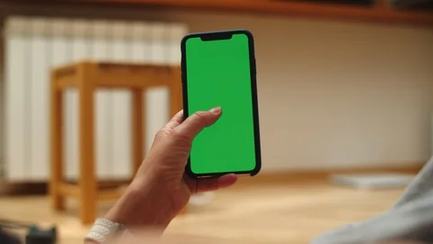 Woman at Home Lying on a Couch using Smartphone with Green Mock-up Screen, Doing Stock-Footage 111405871