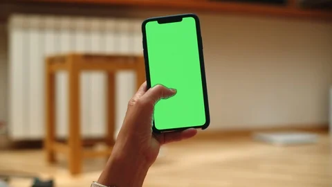Woman at Home Lying on a Couch using Smartphone with Green Mock-up Screen, Doing Stock-Footage 111406546