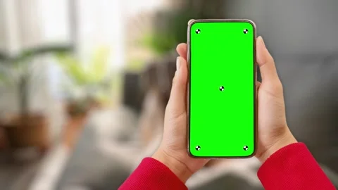 Woman at home lying on couch using smartphone with green mock up screen chroma Stock Footage 306170125