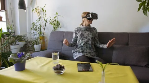 woman at home scared using virtual reali... | Stock Video | Pond5