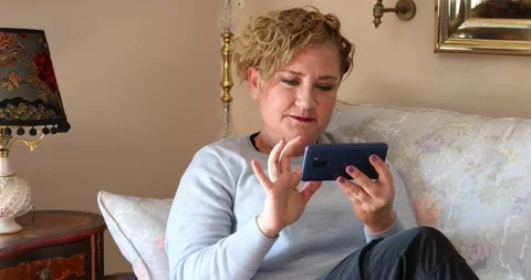 Woman at home using smartphone Stock Footage 150239335