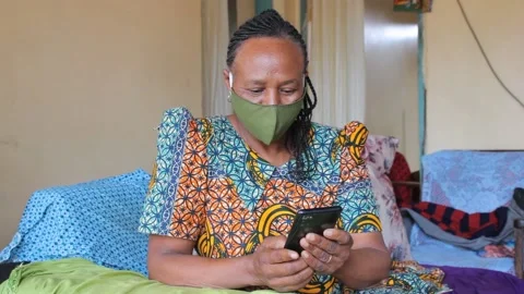Woman at home using smartphone while wearing mask Video stock 162234092