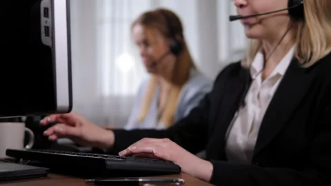 A woman hotline operator working at a computer, she is typing on the keyboard. Stock Footage 299903580