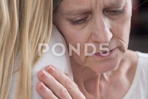 Woman hugging her daughter Stock Photos