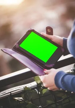 Woman human hands using tablet computer  behind balcony Stock Photos