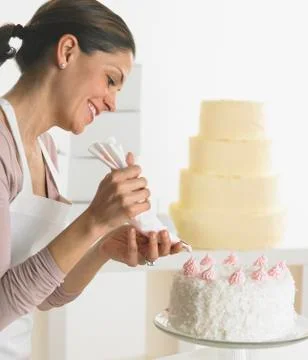 Woman icing a cake Stock Photos