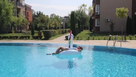 Woman on inflatable pool float in pool in hotel. Summer holidays, enjoying s Stock Footage 268448861