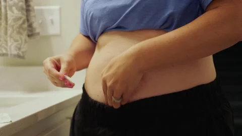 Woman Injecting Self-Administered Auto-Injector Stock Footage 342363811