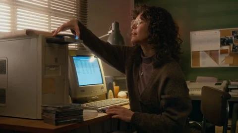 Woman Inserting CD-rom Disk while Working on Vintage Computer at Home Stock Footage 327237901