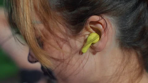 Woman inserting earbuds before workout training 库存影片 336967230