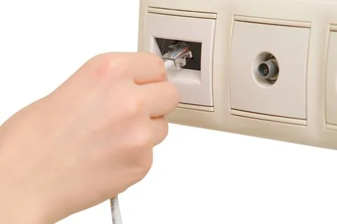 Woman inserting ethernet cable into network wall socket. Internet connection  Stock Photos