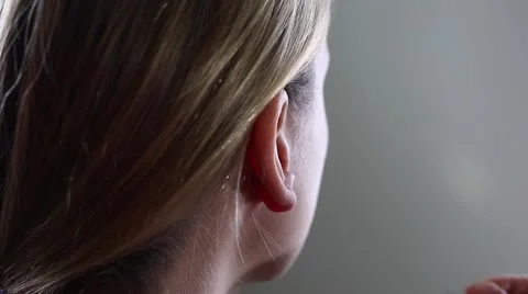 Woman inserts earring Stock Footage 62946507