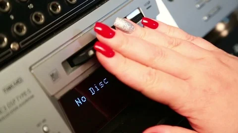 A woman inserts a mini disc into the player Stock Footage 82912423