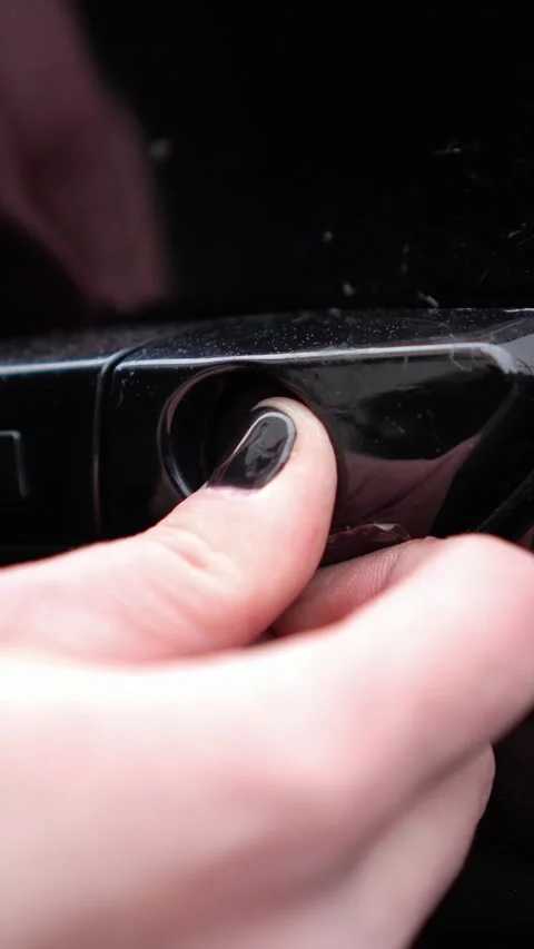 Woman inserts a plug into the car lock slot. . self-repair of the car, replaceme Stock Footage 327932186