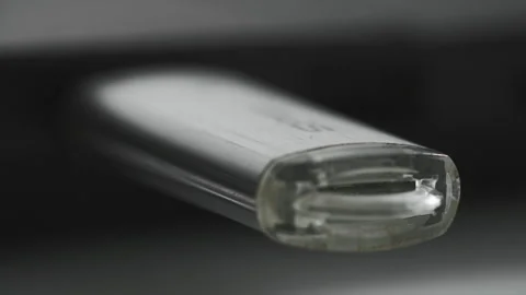 Woman inserts a USB flash drive into a laptop connector for data transfer, close Stock Footage 240859218