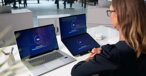 Woman Is Installing A New Software Update On Her Laptop Screen. Stock Photos