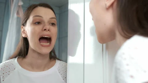 Woman is installing splint for down teeth to correct the bite looking at mirror. Stock Footage 154020171