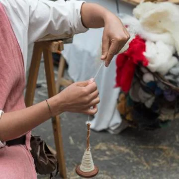 Woman intent on making a piece of string Stock Photos
