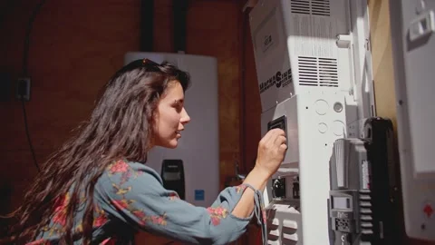 Woman interacting with dials on machine 库存影片 213489302