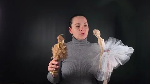 A woman interacting with an object isolated on the black backdrop Stock Footage 276483644