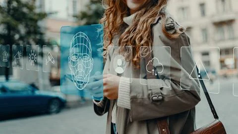 Woman interacts with digital interface in city street showing technology Stock Photos