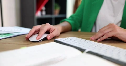 Woman in jacket uses wireless mouse and keyboard for work Stock Footage 279555935
