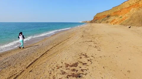 Woman Jogging Along Beach Stock-Footage 64463565