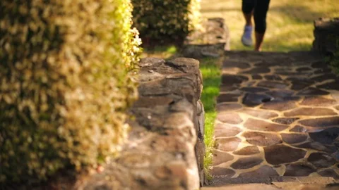 A woman jogging on a footpath. Stockbeeldmateriaal 88444661