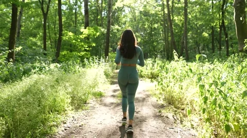 A woman Jogging in the Forest Video stock 249918705