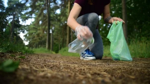 Woman jogging with garbage bag Stock Footage 112975406