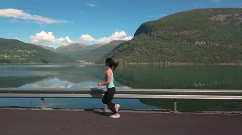 Woman jogging outdoors Stock Footage
