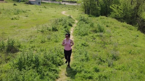 Woman jogging on a path in the nature Stock Footage 307100971