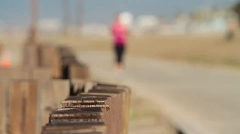 Woman jogs by the beach Stock Footage 46803534