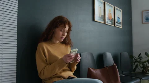 Woman Joyfully Counting Stack of Dollar Bills in Bank Office Stock Footage 310116350