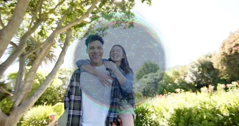 Woman jumping onto man's back, man walking in garden, bubble revealing star grid Stock Footage 334112682