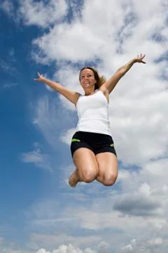 A woman jumping mid-air Stock Photos