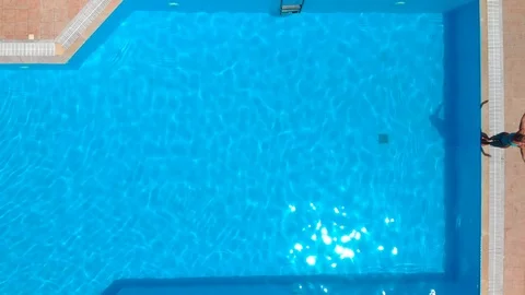 Woman jumping in the pool Stock Footage 91104542