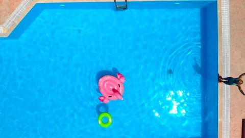Woman jumping in the pool Stock Footage 91104637