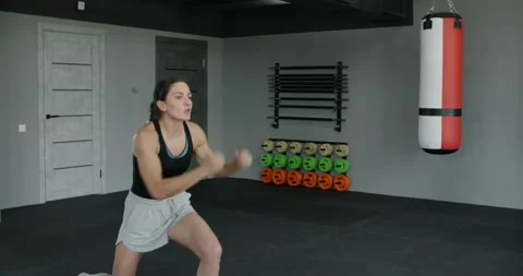 Woman kickboxer does training squats and highkicks in slow motion, female Stock Footage 167336465