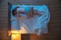 The woman kiss a man on the bed. evening night time. view from above Photo
