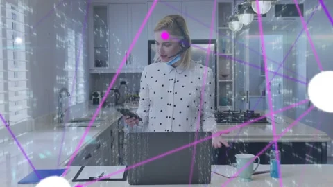 Woman in kitchen checking phone on notification, talking headset, network Stock Footage 333463318